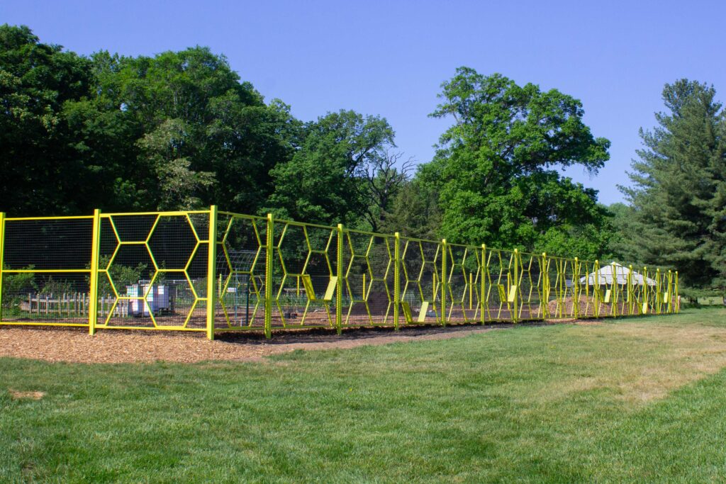 The Washington Youth Garden's new fence features a yellow honeycomb design and front entrance gate.