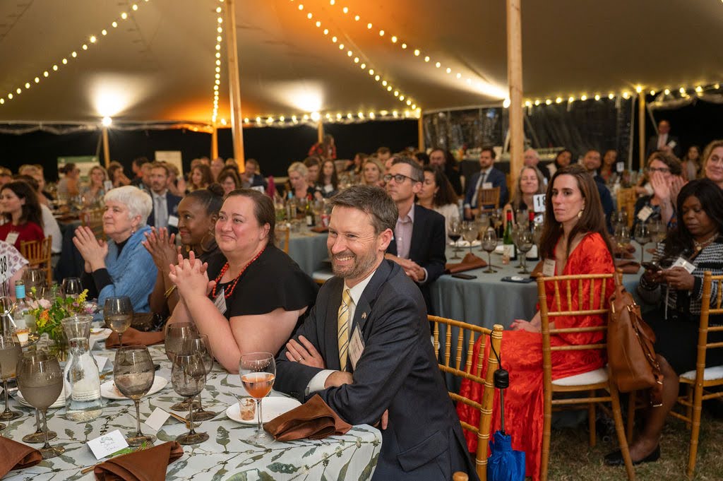 Guests listen to speeches during Dinner Under the Stars