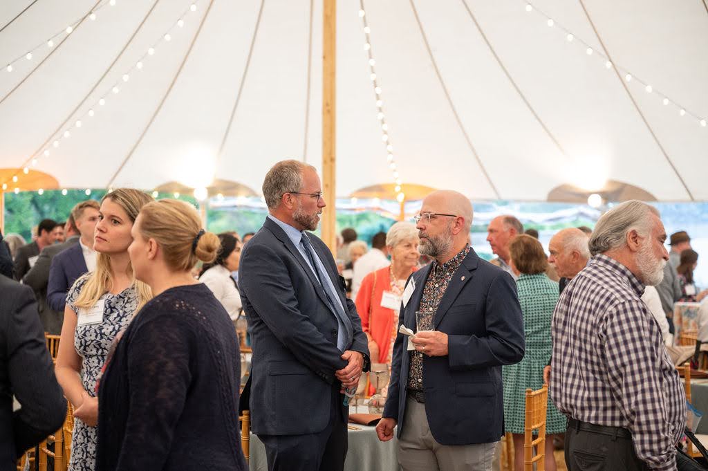 Dr. Richard Olsen talking with a guest during Dinner Under the Stars